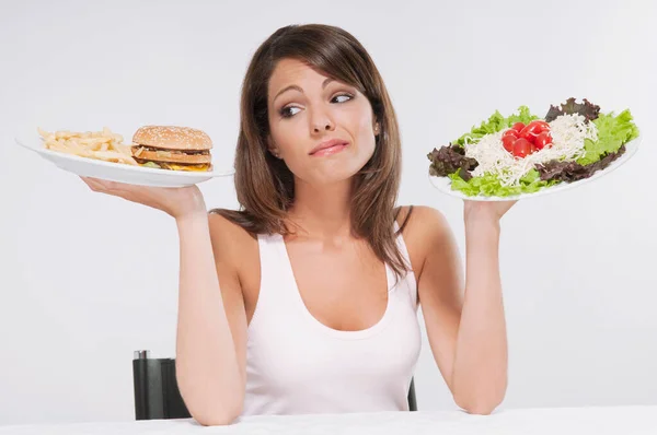 Young Woman Eating Burger Looking Diet Food — Stock Photo, Image