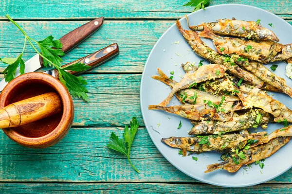 stock image Roasted capelin fish with herbs and lemon zest