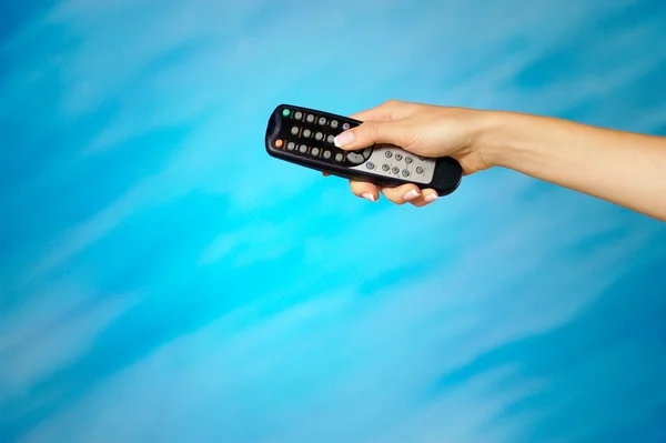 Hand Holding Remote Control Blue Background — Stock Photo, Image