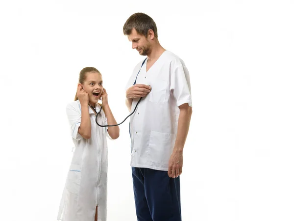 Doctor Put Head Phonendoscope His Heart Girl Medical Coat Listens — Stock Photo, Image