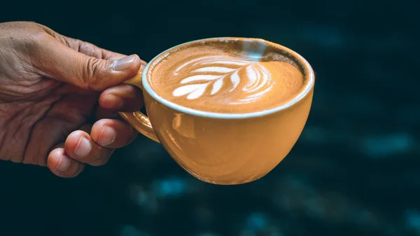 Hand Hold Cup Hot Latte Art Yellow Mug Dark Background — Stok Foto