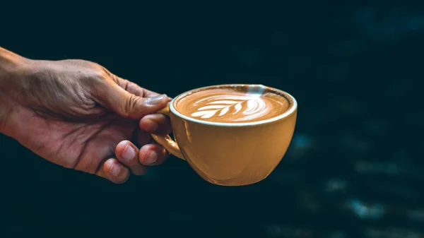 Hand Hold Cup Hot Latte Art Yellow Mug Dark Background — Stok Foto