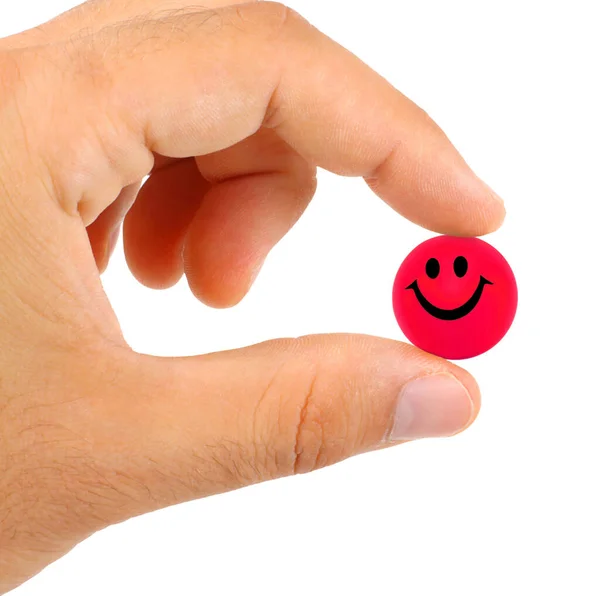 Ball Mit Lächeln Zwischen Den Fingern Auf Weißem Hintergrund — Stockfoto