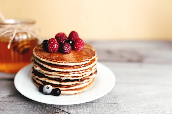 Juicy Pancakes Berries Honey White Plate Spoon Jar Wooden Table — Stock Photo, Image