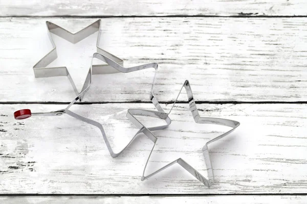 Star shaped pastry cutter on white wooden table
