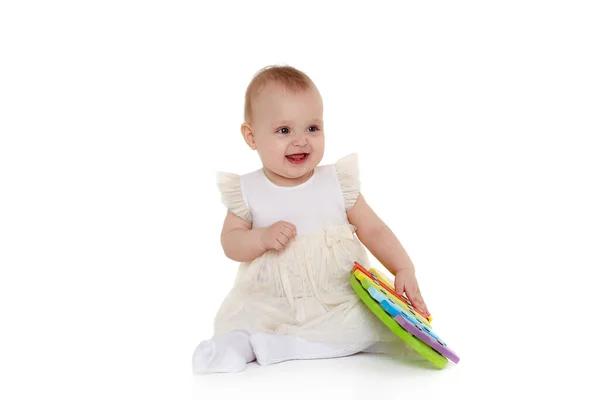 穿着连衣裙的可爱婴儿在白色背景下与五颜六色的木琴 儿童用乐器玩具 早期开发和学习玩具 八个月 — 图库照片