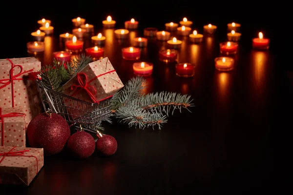 Shopping Trolley Gift Boxes Christmas Decoration Burning Candles Black Background — Stock Photo, Image