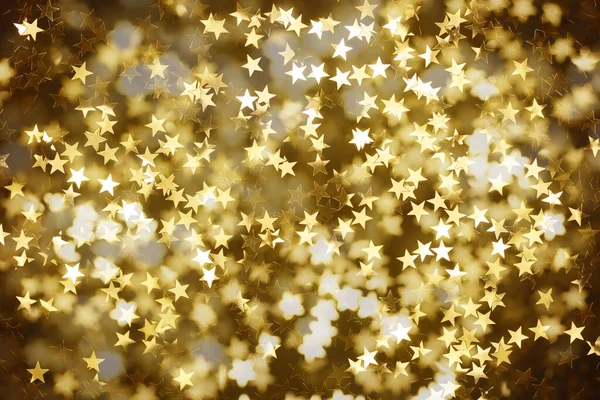 暗い背景に金色の星とクリスマスの背景 — ストック写真