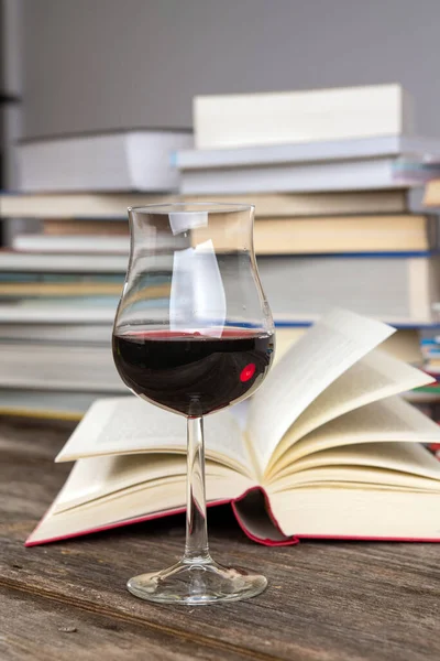 Book Wine Glass Front Piles Different Books Wooden Table — Stock Photo, Image