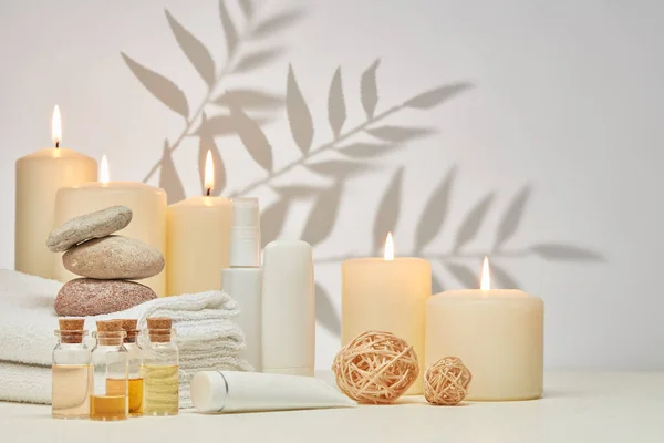 Spa Still Life Creams Essential Oils Burning Candles Stones Towels — Stock Photo, Image