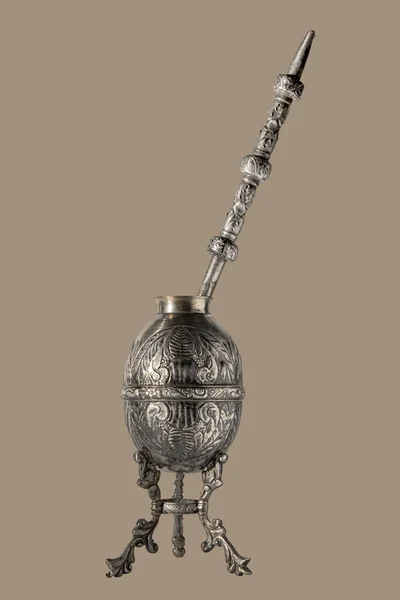 Ancient Argentine mate in silver worked in relief with straw on a light brown background