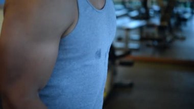 Spor salonundaki kaslı Asyalı adamın portresi vücut ağırlığı egzersizi.