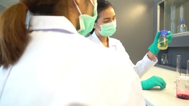 Two Asian Women Scientists Making Tests Pharmaceutical Laboratory — Stock Video