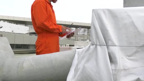 Mannelijke Ingenieur Inspecteur Met Klembord Controle Apparatuur Het Dak Van — Stockvideo