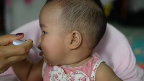 Mother Feeding Cute Asian Baby — Stock Video