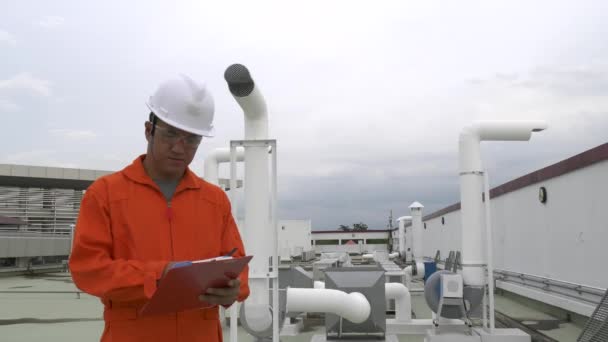 Male Engineer Inspector Clipboard Checking Equipment Roof Plant Speaking Radio — Stock Video