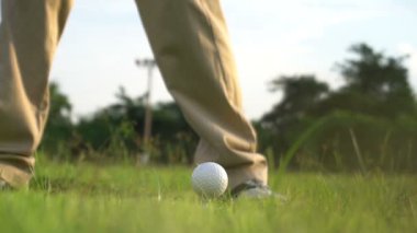 Erkek golfçü çimenli alanda golf oynuyor