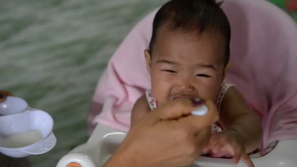 Mother Feeding Cute Asian Baby — Stockvideo