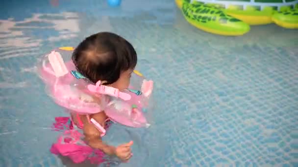 Cute Asian Little Girl Floating Inner Tube Swimming Pool — Stock Video