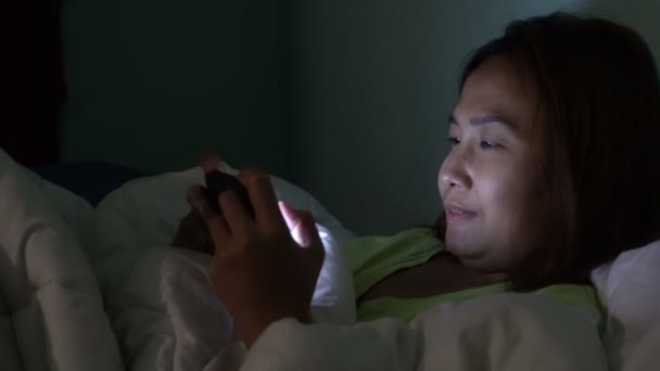 Asian Woman Playing Game Smartphone Bed Night — Stock Video