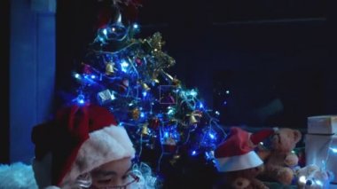 Noel Baba, Noel ağacının yanında çelenkli mektup okuyor. Mutlu tatiller.