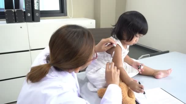 アジアの医師使用して聴診器で呼吸と素敵な女の子の心を確認します — ストック動画