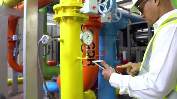 Asian Maintenance engineer at the waste water management system of a huge factory,maintenance checking technical data of heating system equipment,Thailand people — Stock Footage Asian Maintenance Engineer Waste Water Management System Huge Factory Maintenance Royalty Free Stock Video