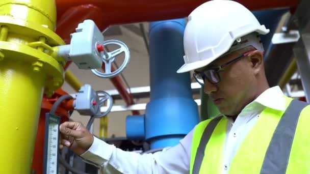 Asian Maintenance engineer at the waste water management system of a huge factory,maintenance checking technical data of heating system equipment,Thailand people — Stock Footage Asian Maintenance Engineer Waste Water Management System Huge Factory Maintenance Royalty Free Stock Video