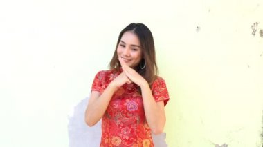 Mutlu Çin yeni yılı. Kırmızı zarflı geleneksel Cheongsam kıyafetleri giyen Asyalı kadın. 
