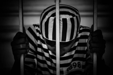 Demir hapishaneyi yakalamak için çırpınan bir adamın portresi, esir konsepti.