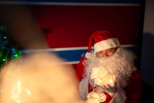 Portrait of santa clause decorate christmas tree in the house