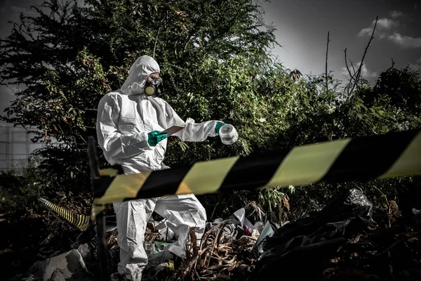 Asian scientist wear Chemical protection suit check danger chemical working at dangerous zone