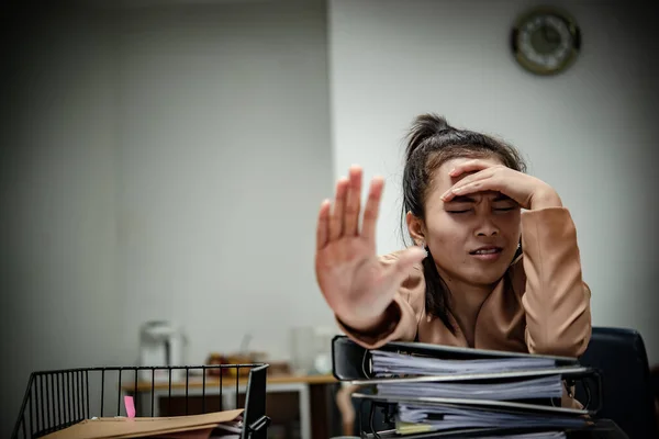 Asian woman working in office,young business woman stressed from work overload with a lot file on the desk