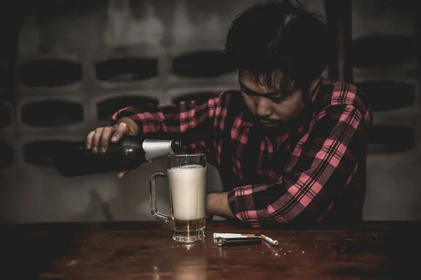 Asian man drink vodka alone at home on night time