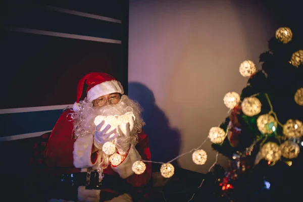 Portrait of santa clause decorate christmas tree in the house