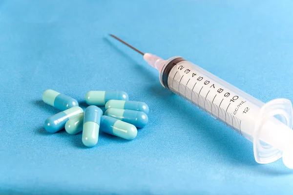 Capsules drug blue on clean blue cloth — Stock Photo, Image