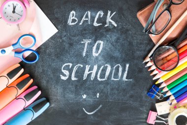 Kara tahta arka plan boş kopya alanı üzerinde okul malzemeleri.