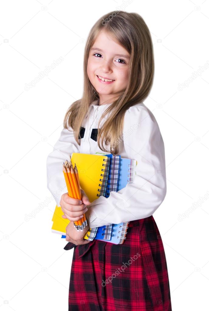 School girl child with school supplies isolated on white.