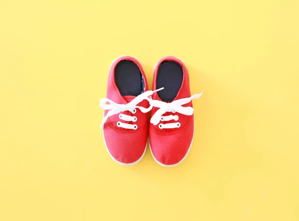 Red Textile Sneakers Pair Top View Empty Space Yellow Background — Stock Photo, Image