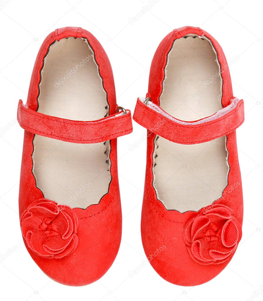 Elegant beautiful red child's shoes pair top view isolated on white.Girl's flats,kid's outgoing footwear.