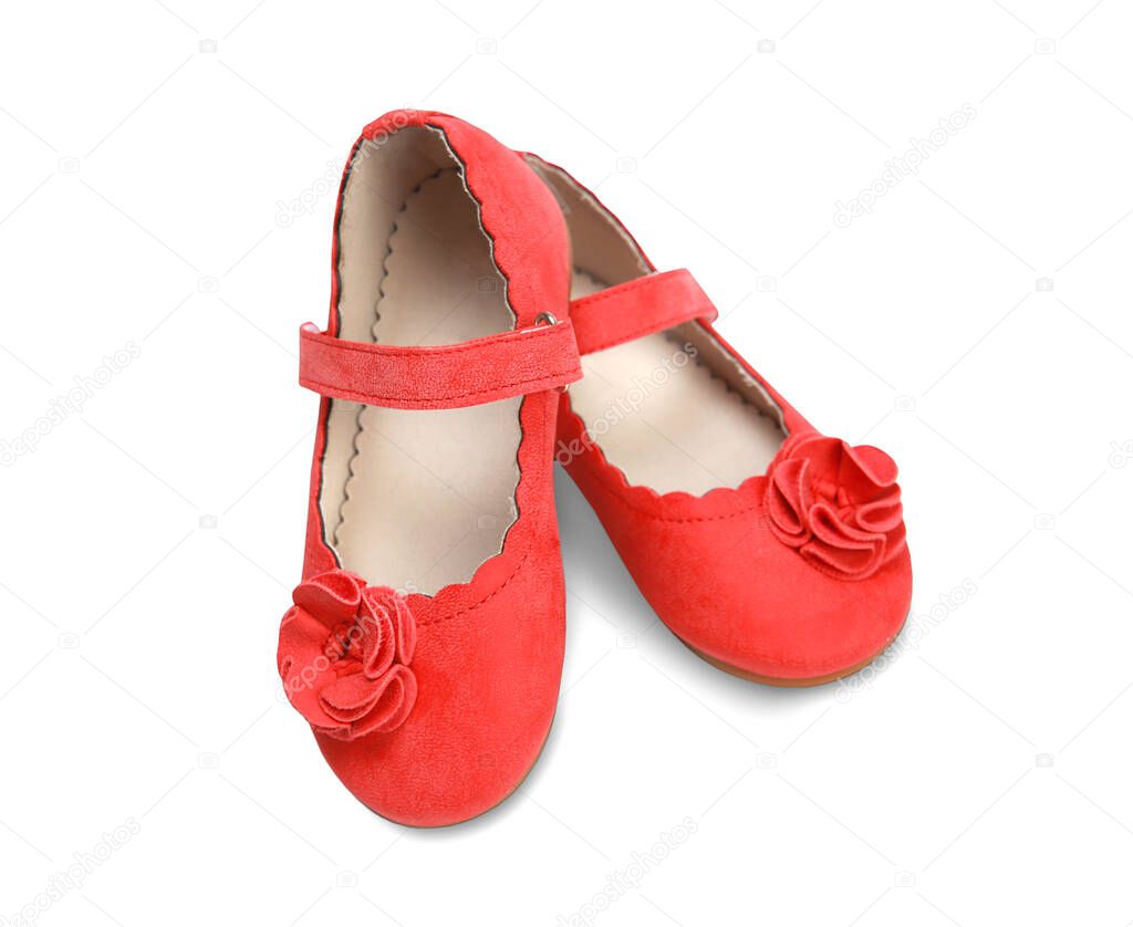 Elegant red baby's shoes pair isolated on white background.Child's flats.Tiny girl's outgoing footwear.