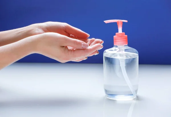 Woman\'s hands and soap bottle,person using antibacterial sanitizer.Coronavirus protection.Hands washing and desinfection.
