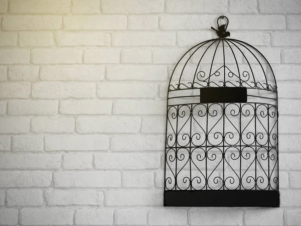 Vintage wall decoration with steel cage on brick — Stock Photo, Image