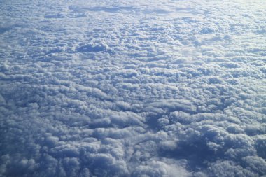 Breathtaking view of the sea of clouds as seen from airplane window during the flight