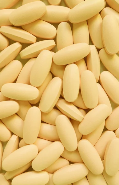 Verticale Afbeelding Van Hoop Romige Gele Ovale Vorm Supplement Pillen — Stockfoto