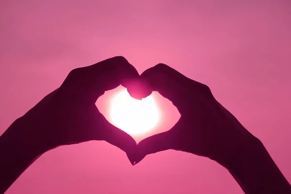 Pembe Renkli Kadın Eli Silueti Parlak Güneşe Karşı Aşk Kalbi — Stok fotoğraf
