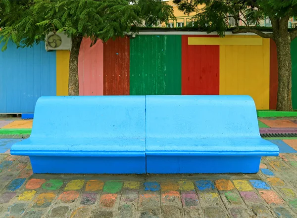 Vivid Blue Concrete Bench in front of Colorful Wooden Wall at La Boca Neighborhood of Buenos Aires, Argentina