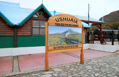 Wooden Signboard in front of the Railway Station TREN DEL FIN DEL MUNDO (Train of the End of the World) and UNA HISTORIA QUE NO SE DETIENE (A History That Does Not Stop), Ushuaia, Argentina clipart