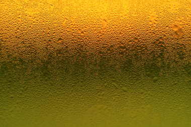 Canlı turuncu ve yeşil renkli cam şişe üzerinde sanatsal yoğunlaşma, doku arka planı