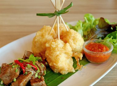 Kızarmış Yapışkan Pirinç Topları Sauteed Beef, taze marul ve Red Chili Dip ile servis edilir.